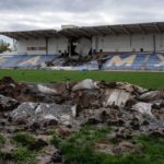 El cráter de un misil perfora un campo de fútbol cerca de un puesto de espectadores que también ha sido alcanzado por un misil, el 21 de octubre de 2022 en Bakhmut, Ucrania.